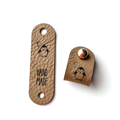 Label 15 x 50 mm abgerundet, mit Niete, Pinguin